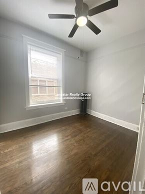 Chicago apartment for rent - A room with a ceiling fan and wooden flooring.