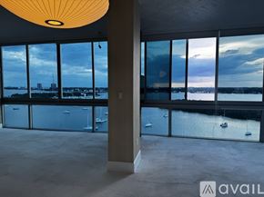 North Bay Village apartment for rent - A room with a large window overlooking a body of water.