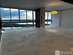 North Bay Village apartment for rent - A spacious room with a large window overlooking a body of water.