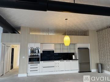 North Bay Village apartment for rent - A modern kitchen with a black countertop and white cabinets.