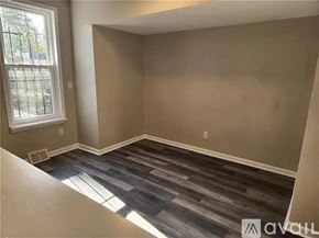 Pittsburgh house for rent - A room with a window and a wooden floor.
