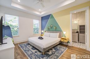 Houston house for rent - A bedroom with a bed, a ceiling fan, and a rug.