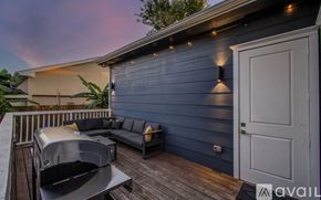 Houston house for rent - A deck with a hot tub and a couch.
