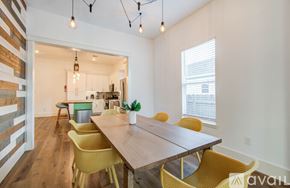 Houston house for rent - A dining room with a wooden table and yellow chairs.