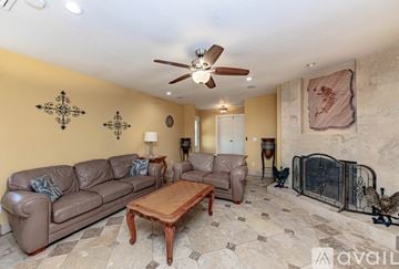 Lake Havasu City house for rent - A living room with a brown couch and a wooden coffee table.