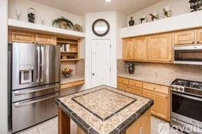 Lake Havasu City house for rent - A kitchen with a granite countertop and stainless steel appliances.