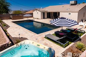 Lake Havasu City house for rent - A backyard with a hot tub and a pool.