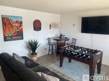 Lake Havasu City house for rent - A living room with a foosball table and a poster of a canyon.