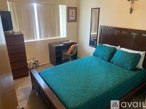 Lake Havasu City house for rent - A bedroom with a bed, desk, and chair.