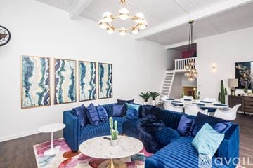 Lake Havasu City house for rent - A living room with a blue couch and a white coffee table.