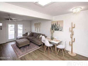 Lake Havasu City apartment for rent - A living room with a couch, chairs, and a table with a vase on it.