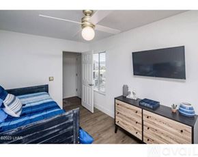 Lake Havasu City apartment for rent - A bedroom with a bed, dresser, and television.