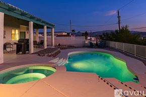Lake Havasu City house for rent - A pool with a hot tub on the side of a house.