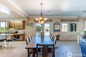 Lake Havasu City house for rent - A dining room with a wooden table and chairs.