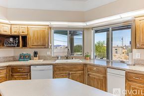 Lake Havasu City house for rent - A kitchen with wooden cabinets and a large island in the middle.