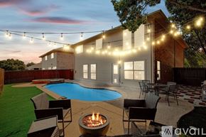 Saginaw house for rent - A house with a pool and a fire pit in the backyard.