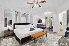 Saginaw house for rent - A bedroom with a large bed and a ceiling fan.