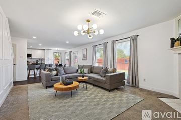 Saginaw house for rent - A living room with a grey couch and a wooden coffee table.