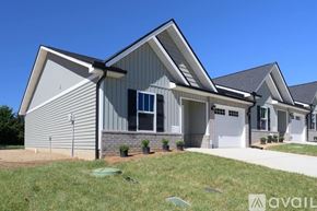 Knoxville townhouse for rent - A modern house with a grey exterior and a white garage door.