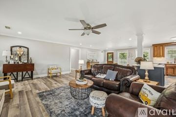 Lascassas house for rent - A living room with a brown leather couch and a wooden coffee table.