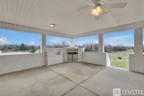 Lascassas house for rent - A spacious room with a ceiling fan and large windows overlooking a field.