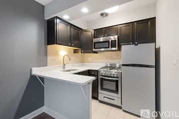 Chicago apartment for rent - A kitchen with black cabinets and stainless steel appliances.