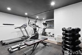 Chicago apartment for rent - A home gym with a treadmill, exercise bike, and weights.