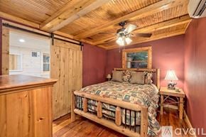 Lakemont house for rent - A bedroom with a bed, wooden dresser, and a ceiling fan.