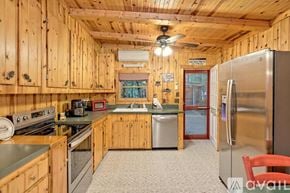 Lakemont house for rent - A kitchen with wooden cabinets and a stainless steel refrigerator.