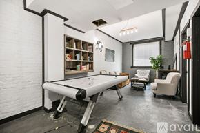Chicago apartment for rent - A room with a pool table and a fire extinguisher on the wall.