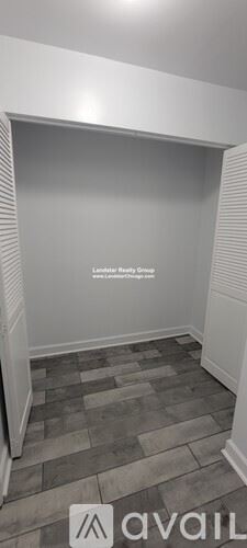 Chicago apartment for rent - A room with a wooden floor and a white wall.