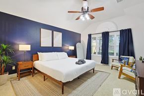 Corinth house for rent - A bedroom with a bed, nightstand, and a ceiling fan.