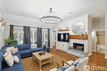 Corinth house for rent - A living room with a blue couch and a wooden coffee table.