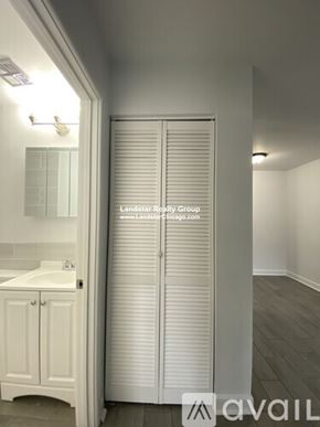 Chicago apartment for rent - A white bathroom with a sink and a white cabinet.