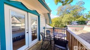San Marcos apartment for rent - A balcony with a table and chairs overlooking a pool.
