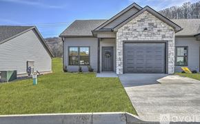 Jonesborough apartment for rent - A house with a grey garage door and a stone facade.