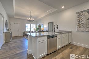 Jonesborough apartment for rent - A modern kitchen with white cabinets and a wooden floor.