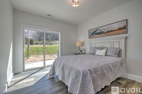 Jonesborough apartment for rent - A bedroom with a large bed and a painting on the wall.