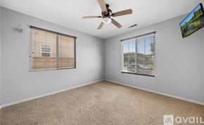 Corona apartment for rent - A room with a ceiling fan and a window with blinds.