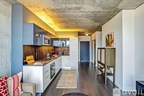 Chicago apartment for rent - A kitchen with a blue wall and a white counter.