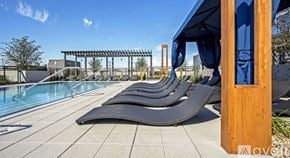 Chicago apartment for rent - A pool with sun loungers and a blue sky.