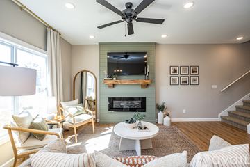 Waynesville apartment for rent - A living room with a fireplace and a television above it.