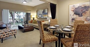 Irving apartment for rent - A living room with a dining table set up with chairs around it.