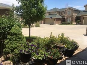 Aurora house for rent - A front yard with a tree and a flower bed.