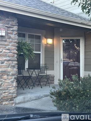 Aurora house for rent - A house with a stone pillar and a patio table.