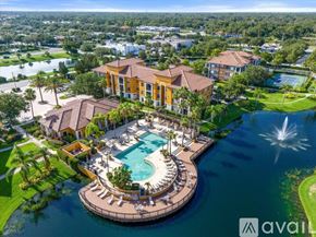 Sarasota condo for rent - A large house with a pool in the middle of a lake.