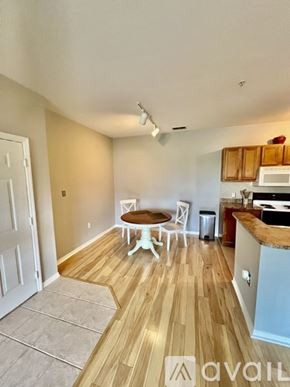 Sarasota condo for rent - A kitchen with a table and chairs in the middle of the room.
