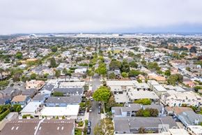 El Segundo house for rent - A view of a city from above with buildings, cars, and trees.