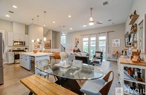 Houston townhouse for rent - A modern kitchen with a glass table and chairs.