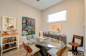 Houston townhouse for rent - A dining room with a glass table and chairs.